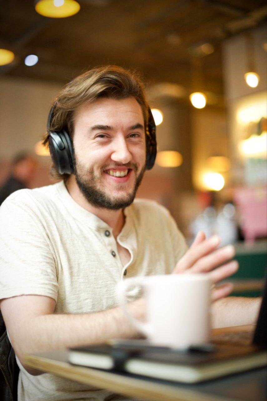 Matt enjoying working at his laptop in a cafe